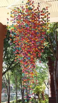 a bunch of colorful butterflies hanging from the ceiling