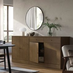 a room with a table, chair and mirror