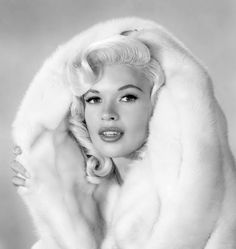 marilyn monroe wearing a fur coat and posing for the camera