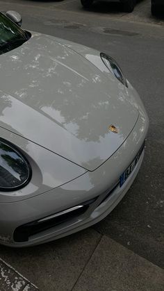 a silver sports car parked on the side of the road