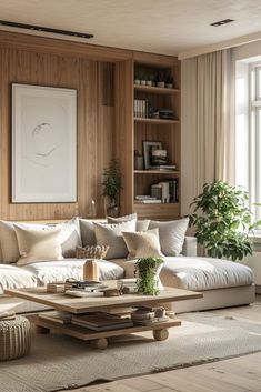 a living room with wood paneling and white couches in front of a window