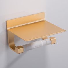 a wall mounted shelf with a paper holder attached to it