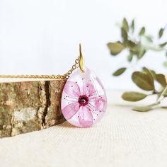 This Cherry blossom necklace is part of my cherry blossom jewelry collection. The sakura flower is highly admired in Japan, so take this sakura flower necklace with you to wear a little piece of this magic beauty. This real flower necklace will never make you go unnoticed because it is really elegant and unique. A cherry blossom necklace to have the Spring always with you... The chain is made of hypoallergenic stainless steel. The resin provides this cherry blossom necklace a perfect crystalline Dainty Blossom Flower Jewelry, Delicate Blossom Color Necklaces, Elegant Blossom Necklace With Flower Charm, Feminine Blossom Flower Jewelry, Feminine Flower-shaped Necklaces For Gifts, Feminine Flower Pendant Necklace Gift For Her, Feminine Flower Pendant Necklace As Gift For Her, Feminine Necklace With Flower Pendant For Her, Feminine Necklace With Flower Pendant As Gift For Her