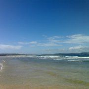 a beach with waves coming in to shore