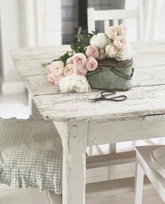 a white table with some flowers on it