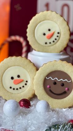 three cookies decorated to look like snowmen