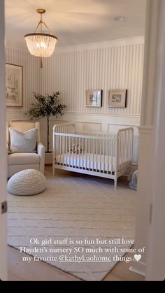 a baby's room with a white crib, chair and ottoman in it