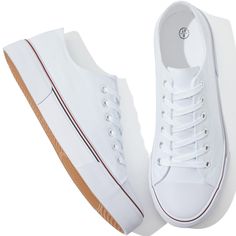 a pair of white tennis shoes sitting on top of each other