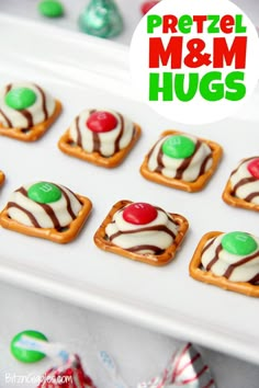 mini pretzel m & m hugs on a white platter with candy candies