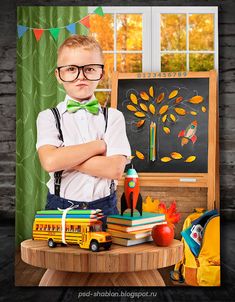 a young boy wearing glasses and suspenders standing in front of a table with school supplies