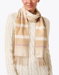 Inspired by traditional Scottish motifs, Johnstons of Elgin's plaid scarf is crafted in versatile neutral hues. It's knit in Scotland from extra-soft cashmere and is finished with a long fringe trim. Layer yours over a sweater and your favorite denim for a touch of sophistication this season. Classic Beige Scarf For Fall, Classic Beige Scarves For Fall, Cream Wool Scarf For Fall, Beige Cashmere Scarves For Fall, Long Fringe, Long Fringes, Fringe Trim, Cashmere Scarf, Plaid Scarf