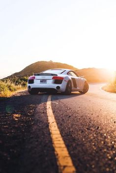 an image of a car driving down the road with arabic writing on it's side