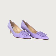 Experience the heightened allure of your everyday essential kitten heel, accentuated by a striking buckle that transforms it into a statement-making pump. It's worth noting, this style stands as our top-seller. The perfect pointy toe mid heel pump! Narrow at toe box Leather upper w/ leather buckle Leather lining Heel Height 2.5" Made in Italy Purple Heels With Buckle Closure For Formal Occasion, Almond Toe Kitten Heels With Buckle Closure For Office, Office Kitten Heels With Almond Toe And Buckle Closure, Office Kitten Heels With Buckle Closure And Almond Toe, Elegant Lavender Heels With Round Toe, Elegant Lavender Heels For Formal Occasions, Purple Low Heel Leather Heels, Lavender Pointed Toe Heels For Formal Occasions, Elegant Lavender High Heels