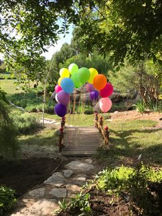 a wooden walkway with balloons tied to it