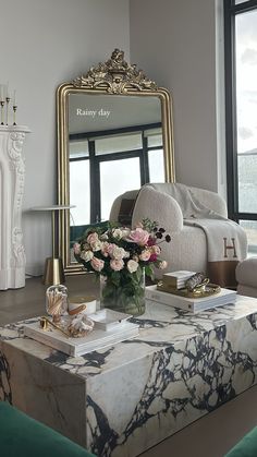 a living room filled with furniture and a large mirror on top of a coffee table