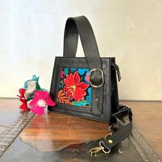 "MADE IN MEXICO Step out in style and make a statement with this exquisite and unique handcrafted leather embroidered bag. No doubt, it'll be the envy of all your friends! For: Women Color: black Dimensions: 9.5 x 8 x 3.5 Details: - 100% Authentic Leather - Style: Top-handle bag - Embroidered design - Top Handle: 5\" - Adjustable & removable strap: 22\" - 1 inner compartment - Zipper closure - Fabric linen - Flat Bottom - Gold Hardware FOR MORE DETAILS PLEASE CONTACT US. PLEASE READ BEFORE PURCHASE: The picture is an ACCURATE REPRESENTATION. Colors in the pictures may vary a little by the effects of light. Each product is handmade from Mexico causing differentiation and minor imperfections in each piece making them that much more unique. We strive to have consistency within our business bu Rectangular Embroidered Satchel For Everyday Use, Embroidered Handheld Satchel For Everyday, Embroidered Double Handle Satchel For Everyday Use, Everyday Embroidered Handheld Satchel, Embroidered Satchel For Everyday Use, Floral Embroidery Top Handle Bag For Everyday Use, Embroidered Satchel, Embroidered Leather Satchel For Everyday Use, Top Handle Bags With Floral Embroidery For Everyday