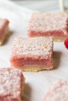 raspberry shortbreads are sitting on top of a piece of parchment paper