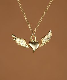 Flying heart necklace, silver heart pendant with wings, wing necklace, a 14k gold vermeil heart and wings on a 14k gold filled chain This super cute and dainty 14k gold plated sterling silver flying heart hangs from a 14k gold filled chain in the length of your choice! This beauty is also available in sterling silver and the pendant measures 22mm x 8mm. Looking for other charm necklaces? https://www.etsy.com/shop/BubuRuby?section_id=12318467 More crystals and healers? http://www.etsy.com/shop/Bu Flying Heart, Heart Necklace Silver, Wing Necklace, Silver Heart Pendant, Charm Necklaces, Silver Heart Necklace, Gold Filled Chain, Gold Bangles, Necklace Silver