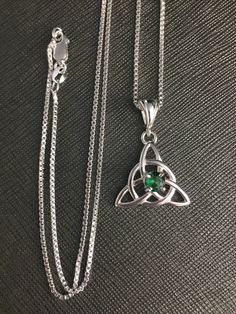 Did you enjoy Charmed, the TV show? I'll fabricate this sterling silver Celtic Trinity Knot pendant, approximately 1 inch in diameter, and I will set your choice of a 6mm round faceted or cabochon gemstone from the drop down menu. This comes with a 16 inch sterling silver box chain at 1.2mm thickness with a lobster claw for secure attachment. This is shown with a classic green Lab emerald faceted gemstone for the lucky lass in you! It's lovely, graceful and elegant...a timeless and classic tradi Fine Jewelry Silver Necklace For May Birthstone, Silver Fine Jewelry Necklace For May Birthstone, Spiritual Sterling Silver Birthstone Necklace With Gemstone, Spiritual Sterling Silver Necklace For May Birthstone, Silver Sterling Jewelry For May Birthstone, Silver Emerald Gemstone Necklace, White Gold Emerald Necklace In Sterling Silver As Gift, Spiritual Sterling Silver Jewelry For May Birthstone, Sterling Silver Necklace For May Birthstone