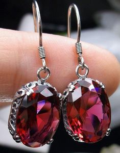 Simulated Red Ruby Solid Sterling Silver Earrings Edward Design#E70 This is a pair of antique-inspired Edwardian style earrings. The flawless oval simulated red Ruby gems are surrounded by delicate sterling silver filigree. The lovely full cut oval stones are approximately 14mm by 10mm in length & width. The earrings are 1.25 inches long and are marked 925 for solid sterling silver. Notice the beautiful floral craftsmanship of the filigree settings. The gemstones are cut to reflect light, cr Red Ruby Earrings With Intricate Design, Red Oval Ruby Earrings, Ornate Oval Red Jewelry, Red Oval Garnet Earrings, Red Garnet Oval Earrings, Elegant Oval Garnet Earrings, Oval Red Ruby Earrings, Victorian Red Oval Earrings, Red Oval Gemstone Earrings