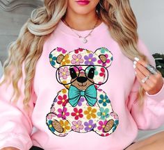 Colorful Daisy Teddy Bear Spring Sweatshirt | Unique Gifts for Family Friends   Embrace the spirit of spring with our vibrant color palette, featuring pastel hues and refreshing tones that capture the essence of nature's awakening. Whether you're strolling through blooming gardens or enjoying a picnic in the park, our crewnecks effortlessly elevate your spring wardrobe. Stay cool and comfy with our spring crewnecks.   Key Features: High-Quality Material: Made from soft and durable fabric, this sweatshirt is built to last and keep you cool and comfy. Unisex Design: This versatile pullover suits all genders, offering a relaxed and comfortable fit. Charming Appeal: Our spring sweatshirts are designed to add a touch of charm to your seasonal attire, making you stand out in style.   Physical At Pink Casual Sweatshirt With Floral Print, Pink Floral Print Casual Sweatshirt, Casual Pink Floral Print Sweatshirt, Trendy Multicolor Sweatshirt For Spring, Pastel Crew Neck Top For Spring, Pastel Crew Neck Spring Top, Cute Green Sweatshirt For Spring, Spring Sweatshirt, Picnic In The Park