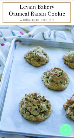 several oatmeal raisin cookies on a baking sheet with text overlay