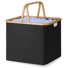 a black cooler with a wooden handle and blue blanket inside it on a white background