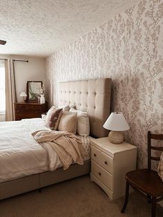 a bed sitting next to a window in a bedroom