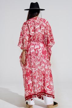 Introducing our enchanting Red Long Kimono with Drawstring Closing in Tribal Print, a must-have piece for your summer wardrobe. This maxi-length kimono features a captivating tribal print that adds a touch of bohemian flair to any ensemble.  Crafted from a lightweight chiffon fabric blend of 70% viscose and 30% polyamide, this kimono is perfect for layering over your favorite swimsuit as a stylish beach cover-up. The 3/4 length sleeves and relaxed fit ensure comfort and ease of movement, while the drawstring closing adds a customizable touch to your look.  Complete with fringe trim details at the bottom, this kimono exudes casual elegance with a hint of boho-chic charm. Whether you're lounging by the pool or strolling along the beach, this kimono is sure to keep you looking effortlessly st Scarf Headband, Long Kimono, Fringe Trim, Estilo Boho, Romper Pants, Trim Detail, Casual Elegance, Sweater Coats, Chiffon Fabric