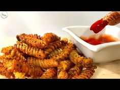 some food that is on a table with sauce in the bowl and another dish next to it