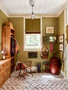 a room with green walls and wooden furniture