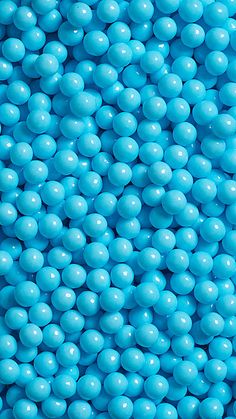 blue candies are stacked on top of each other in the shape of a ball