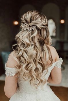 the back of a bride's head with her hair in half - up style