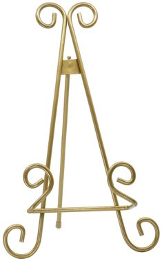 a gold metal easel with two curved arms and a letter on the front side