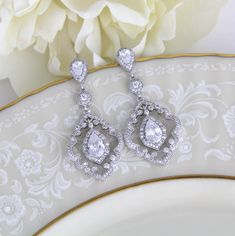 "Vintage style dangle earrings have the drama of 1920's platinum and diamond jewelry. At 1 3/4\" h x 3/4\" w, these beautiful bridal earrings are a must-have for the bride seeking a one-of-a-kind design for her wedding day! With silver pave scrolls and micro pave dangles, these CZ earrings have the elegance of genuine vintage heirlooms. Matching necklace; https://www.etsy.com/listing/261838550/art-deco-necklace-crystal-wedding" Classic Chandelier Earrings With Elegant Design, Classic Chandelier Drop Earrings With Elegant Design, Classic Drop Chandelier Earrings For Wedding, Elegant Chandelier Drop Earrings For Anniversary, Ornate Wedding Diamond Drop Earrings, Classic Cubic Zirconia Chandelier Earrings For Wedding, Classic Chandelier Dangle Earrings For Wedding, Classic Chandelier Earrings With Intricate Design For Anniversary, Ornate Dangle Bridal Earrings For Anniversary