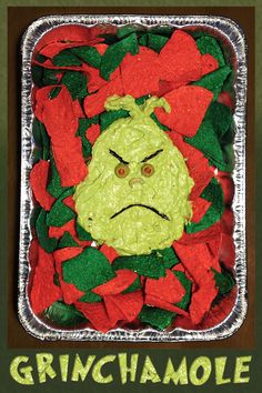 a square tin container filled with green and red chips covered in food that has a frowning face on it