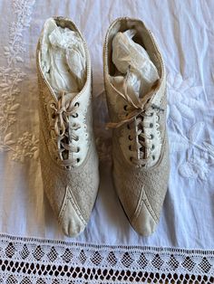 These are really nice shoes from the 1890's. They are a beige  woven cloth fabric with  leather detailing on toes and top. Oxford style with original ties. Inside is lined in leather at the back and a cloth towards the front. No label or size inside.  They measure 9 1/2 inches long and are 2 1/2 inches across widest.. 1 1/2inch heels.  Condition is good to very good  for their age. . There are some spots and discoloration - darkening. See pics. 1890s Shoes, 2inch Heels, Oxford Style, Leather Detailing, Cloth Fabric, Dark Beige, Tie Shoes, Nice Shoes, Really Cool Stuff