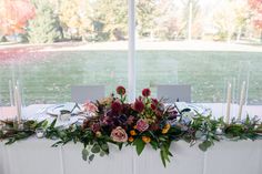 a table with flowers and candles on it