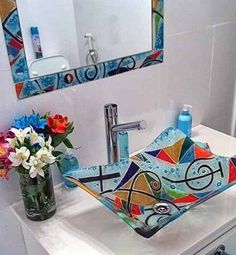 a bathroom sink with colorful art on it