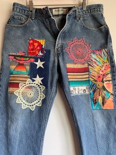 the jeans are decorated with colorful patches and designs