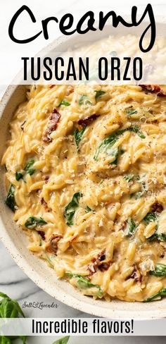 creamy tuscan orzo in a white bowl with spinach leaves on the side