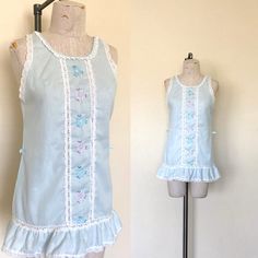 "- Vintage 1980's era lace and embroidered sleeveless nightie  - Fabric label is unreadable, Feels like a super lightweight cotton woven - Light blue with white lace trim around neckline, armholes, bottom edge, and down center front on both sides of embroidery - Pink and light blue flowers embroidered down center fornt - Ruffled edge on bottom - Back side is plain - Waist has two belt loops at side seam  SIZE: Label says Petite, Fits like a Small/Medium LABEL: Gilead MEASUREMENTS: Chest 36\", Wa Flowers Embroidered, Long Sleeve Cocktail Dress, Light Blue Flowers, Lace Sleeveless Top, 1980s Dresses, Fabric Labels, Navy Lace, Denim And Lace, Size Label