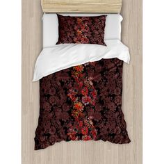 an image of a bed with red and black floral print on the comforter set