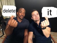 two men sitting on a couch holding up signs with the words delete it in front of them