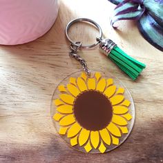 a sunflower keychain with a tassel hanging from it's center