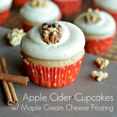 cupcakes with white frosting and walnuts on the top, surrounded by cinnamon sticks