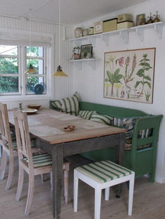 a dining room table with green chairs and white walls