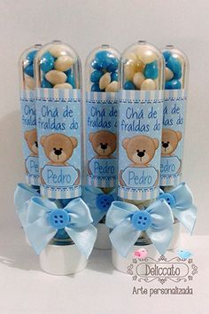 three bottles filled with blue and white candies