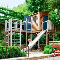 a child playing on a slide in the backyard