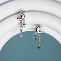 These cute dainty moon and stars stud earrings features a cute crescent moon and a trail of stars drop, made of solid 925 sterling silver and platinum plating. Add these elegant moon and stars stud drop earrings to your everyday fine jewelry collection or as a gift for your love one. Material: sterling silverFinish: platinum plateDimensions: 0.76 x 0.27 in Jewelry Care: See more information about how to care for your jewelry here. Shipping Policy: Orders will be shipped within 1-3 business days. Silver Moon Jewelry, Moon Earrings Aesthetic, Moon Jewelry Silver, Cute Silver Earrings, Moon Earrings Silver, October Jewelry, Moon With Stars, Lunar Jewelry, Moon Accessories